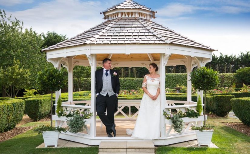 Couple standing in gazebo at The Lawn
